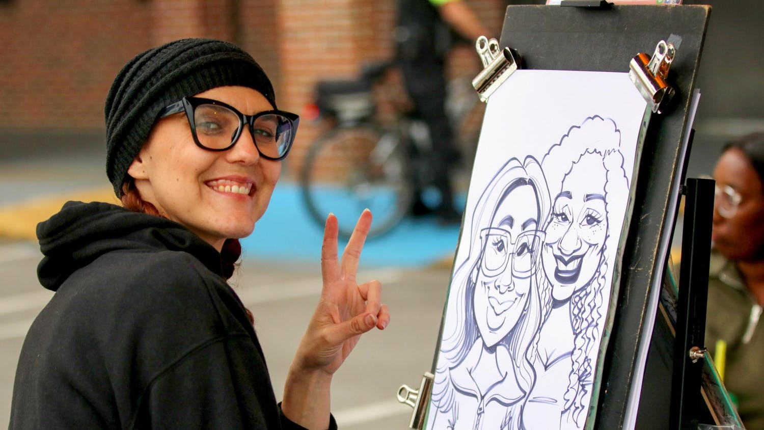 Orlando, Florida, resident Sara Davis draws a caricature of two people at the South Carolina State Fair on Oct. 10, 2025. The fair ran from Oct. 8 to 19.