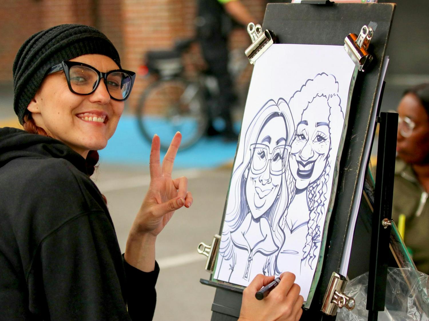 Orlando, Florida, resident Sara Davis draws a caricature of two people at the South Carolina State Fair on Oct. 10, 2025. The fair ran from Oct. 8 to 19.