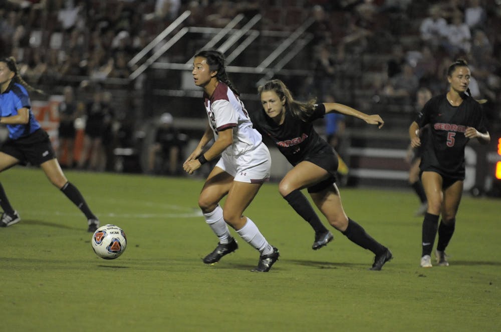 Former graduate midfielder Lauren Chang looks down the field to pass to her teammate as she leaves the Georgia defender behind on Oct. 15, 2021. South Carolina tied with Georgia 0-0