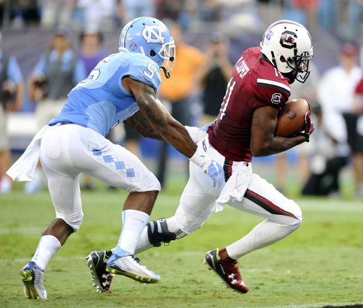 South Carolina wide receiver Pharoh Cooper (11) runs past North Carolina&apos;s Juval Mollette (5) on his way to a 9-yard touchdown during the first half in the Belk College Kickoff at Bank of America Stadium in Charlotte, N.C., on Thursday, Sept. 3, 2015. (David T. Foster III/Charlotte Observer/TNS)