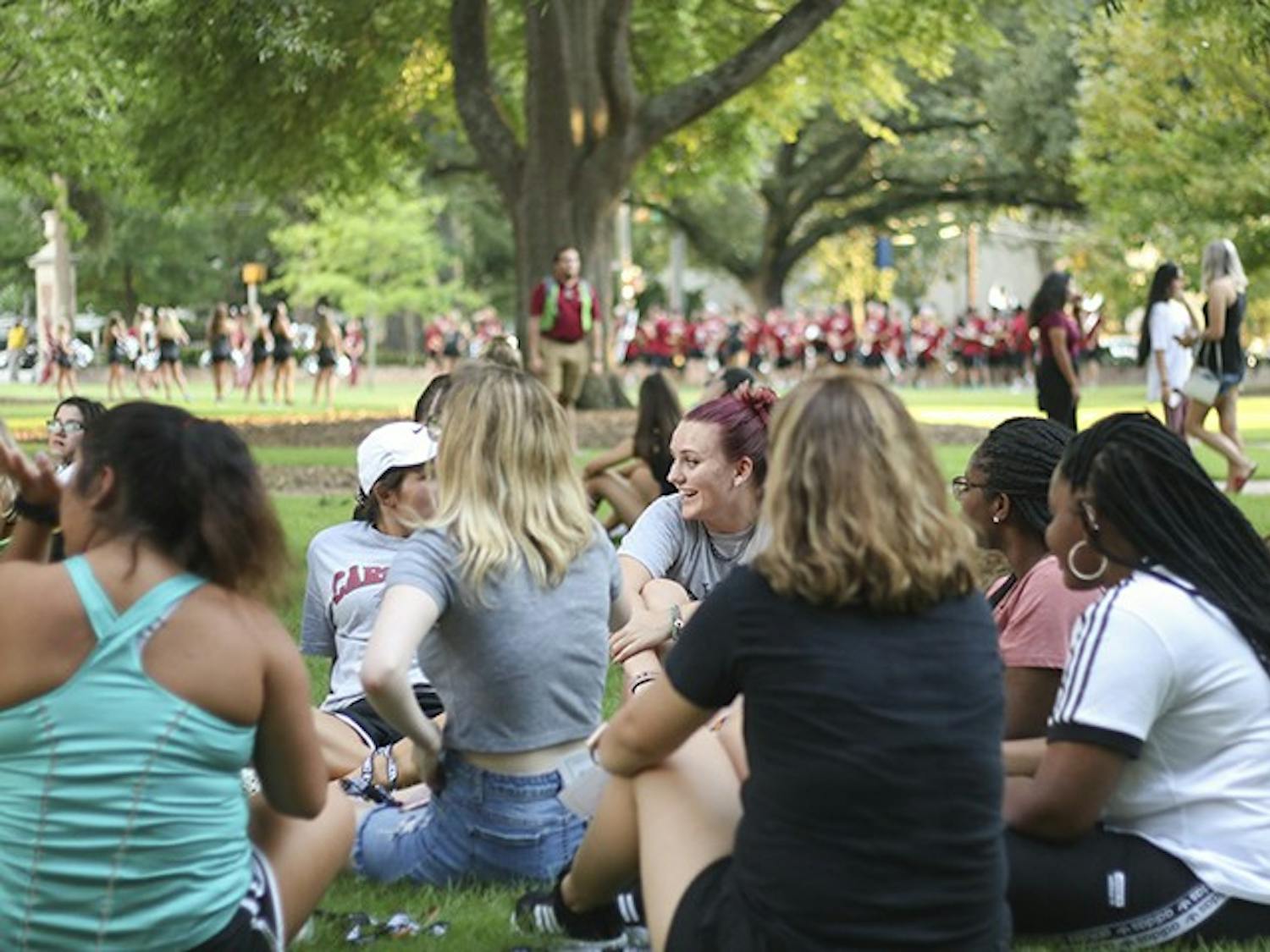 Students laugh and talk as they wait for "First Night Carolina" festivities to begin on the horseshoe, Wednesday evening.&nbsp;
