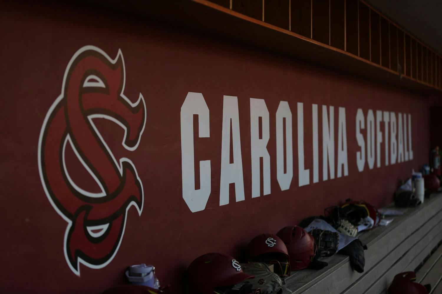 The University of South Carolina softball logo is seen underneath one of the dugouts during South Carolina's matchup against Massachusetts at Beckham Field on Feb. 24, 2024. The Gamecocks finished its season 36-24.