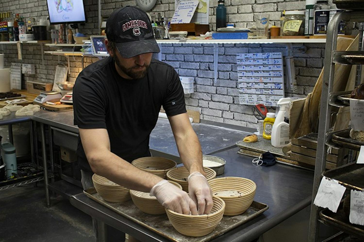 &nbsp;Owner of Crust Bakehouse Zackery Gates works in the kitchen to prep inventory.&nbsp;