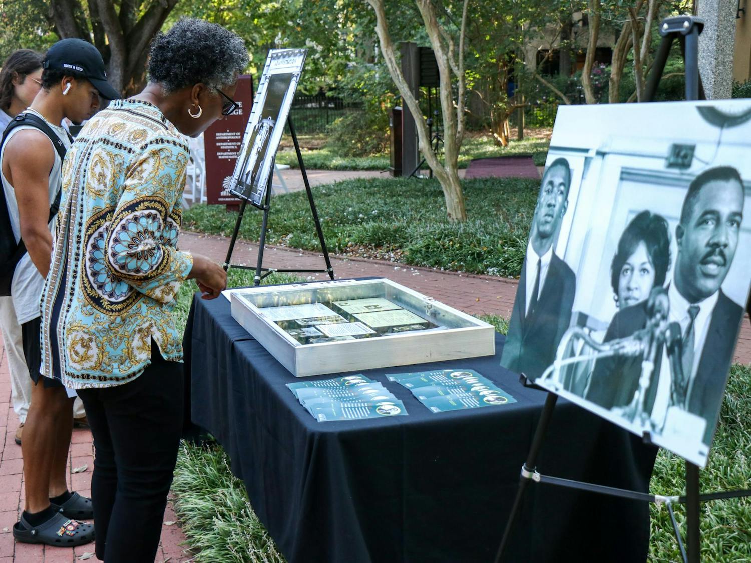 A woman looks at a desegregation display outside of LeConte College on Sept. 11, 2023. The College of Arts and Sciences revealed a plaque in honor of James L. Solomon Jr. after the commemoration and groundbreaking for the desegregation monument in front of McKissick Museum.