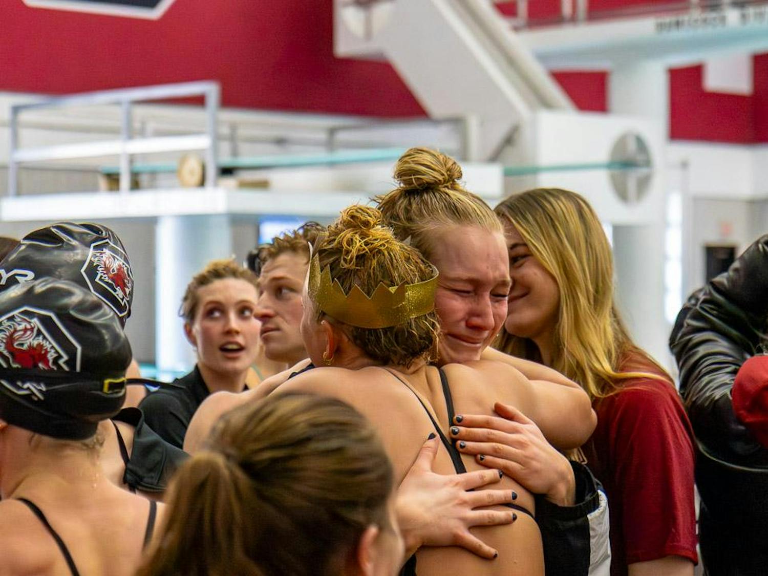 Senior breaststroke and individual medley swimmer Georgia Johnson (left) hugs senior freestyle swimmer Hayley Mason after the tri-meet against Duke University and UNC Asheville on Jan. 20, 2024. Smiles, laughter and tears were shared after the graduating seniors' last home meet at the Carolina Natatorium.