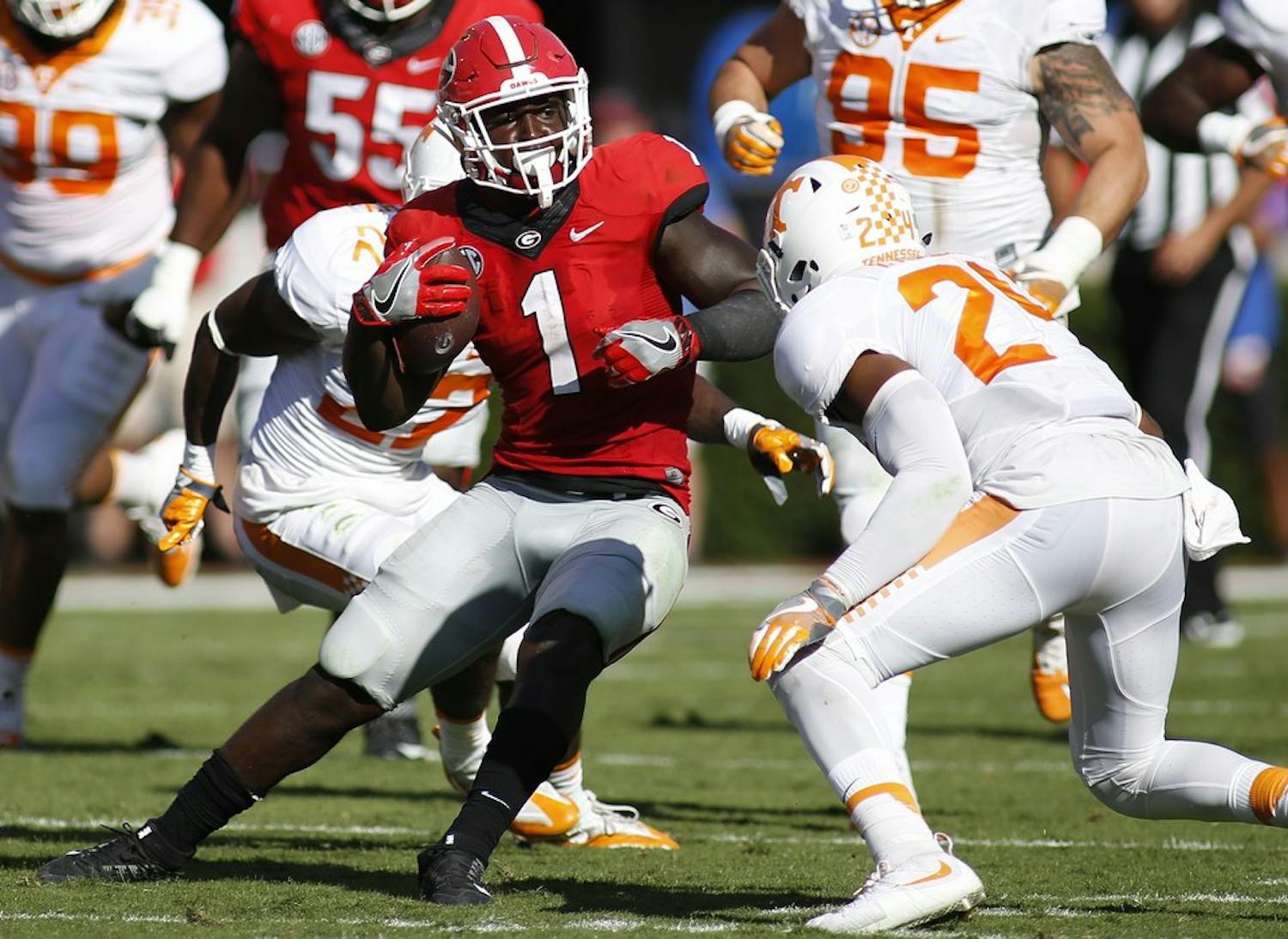 Georgia tailback Sony Michel (1) jukes to avoid a tackle from Tennessee defensive back Todd Kelly Jr. (24) during the first half of a NCAA college football game between Georgia and Tennessee, in Athens, Ga., on Saturday, October 1, 2016. (Joshua L. Jones/special)