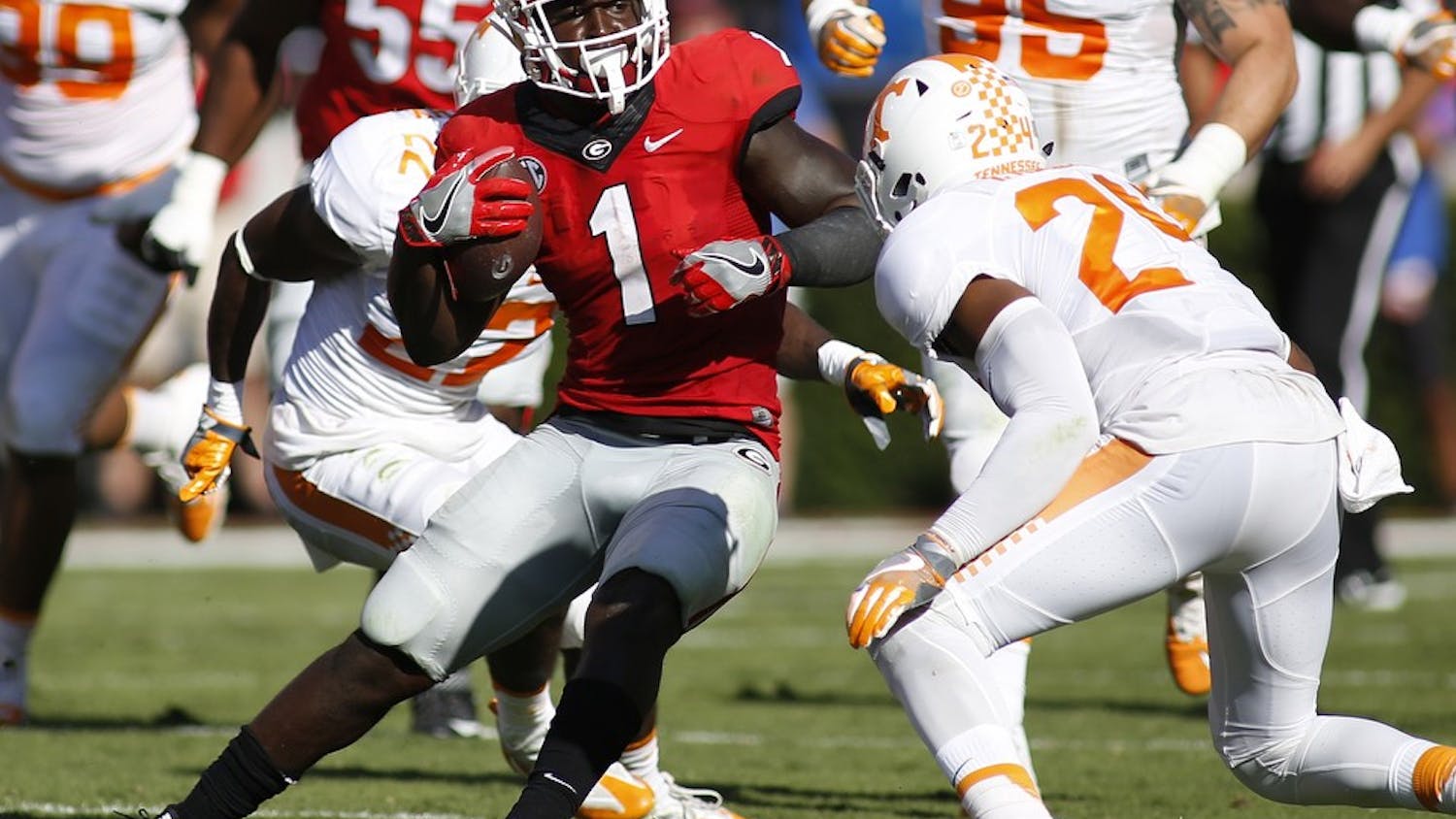 Georgia tailback Sony Michel (1) jukes to avoid a tackle from Tennessee defensive back Todd Kelly Jr. (24) during the first half of a NCAA college football game between Georgia and Tennessee, in Athens, Ga., on Saturday, October 1, 2016. (Joshua L. Jones/special)