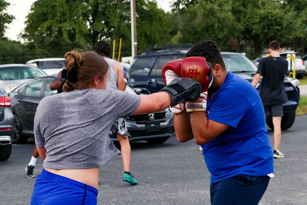<p>Carolina Boxing Club members Sophie Jolley and David Trav exchange &nbsp;jabs during a boxing practice on Monday afternoon, Sept. 12, 2022, at Battle Boxing Gym in Columbia, S.C. The Fighting Gamecock Boxing Club gather Mondays, Wednesdays and Fridays in preparation for matches later this season.</p>