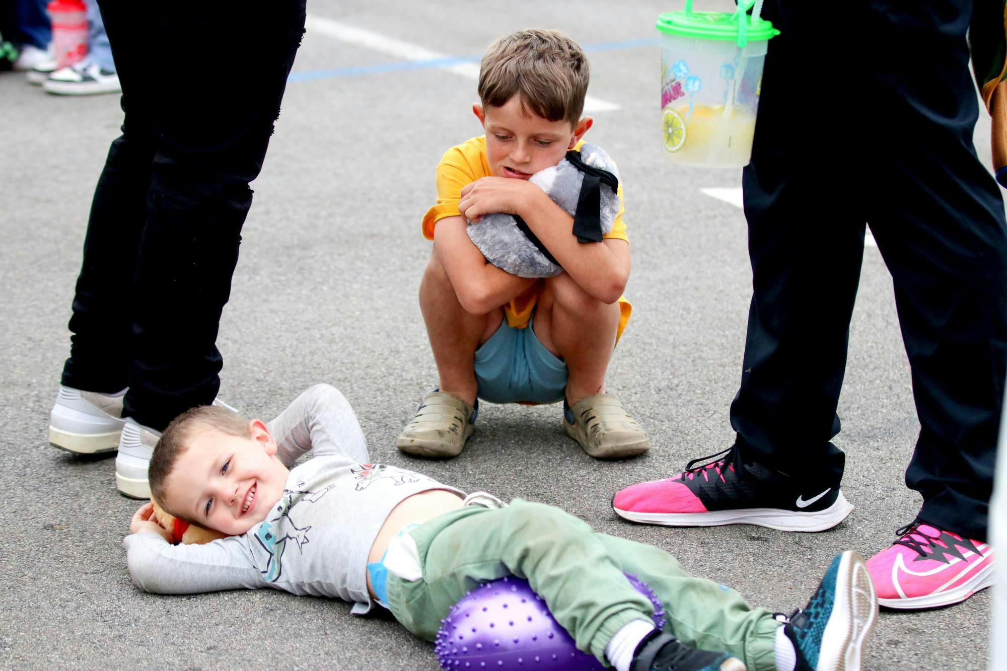 Prosperity, South Carolina, resident Warden lays on the ground in front of his brother Drew at the South Carolina State Fair on Oct. 10, 2025. The fair offered numerous activities, including rides, carnival games, food vendors, livestock competitions and live performers.
