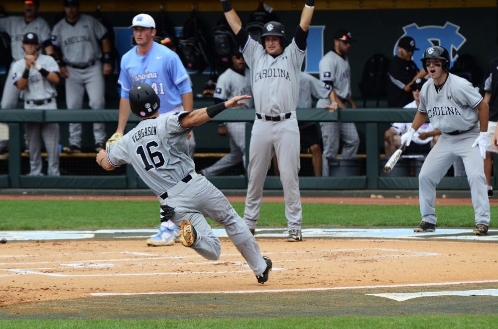 Chase Vergason slides in to home plate to score in the first innning.