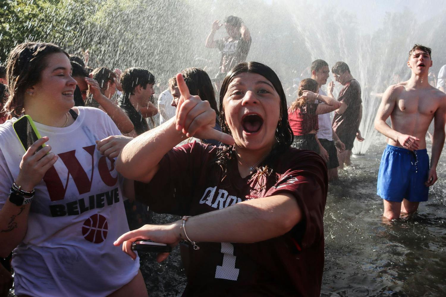 A University of South Carolina student celebrates in the Thomas Cooper Fountain following the women's basketball team's victory in the final round of the 2024 NCAA Women's Tournament on April 7, 2024. Students gathered around the fountain before the start of the game's fourth quarter.