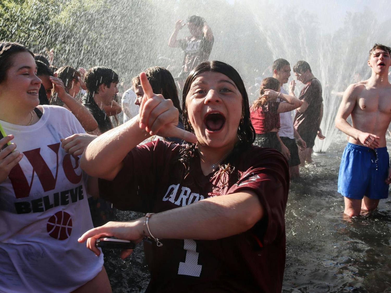 A University of South Carolina student celebrates in the Thomas Cooper Fountain following the women's basketball team's victory in the final round of the 2024 NCAA Women's Tournament on April 7, 2024. Students gathered around the fountain before the start of the game's fourth quarter.