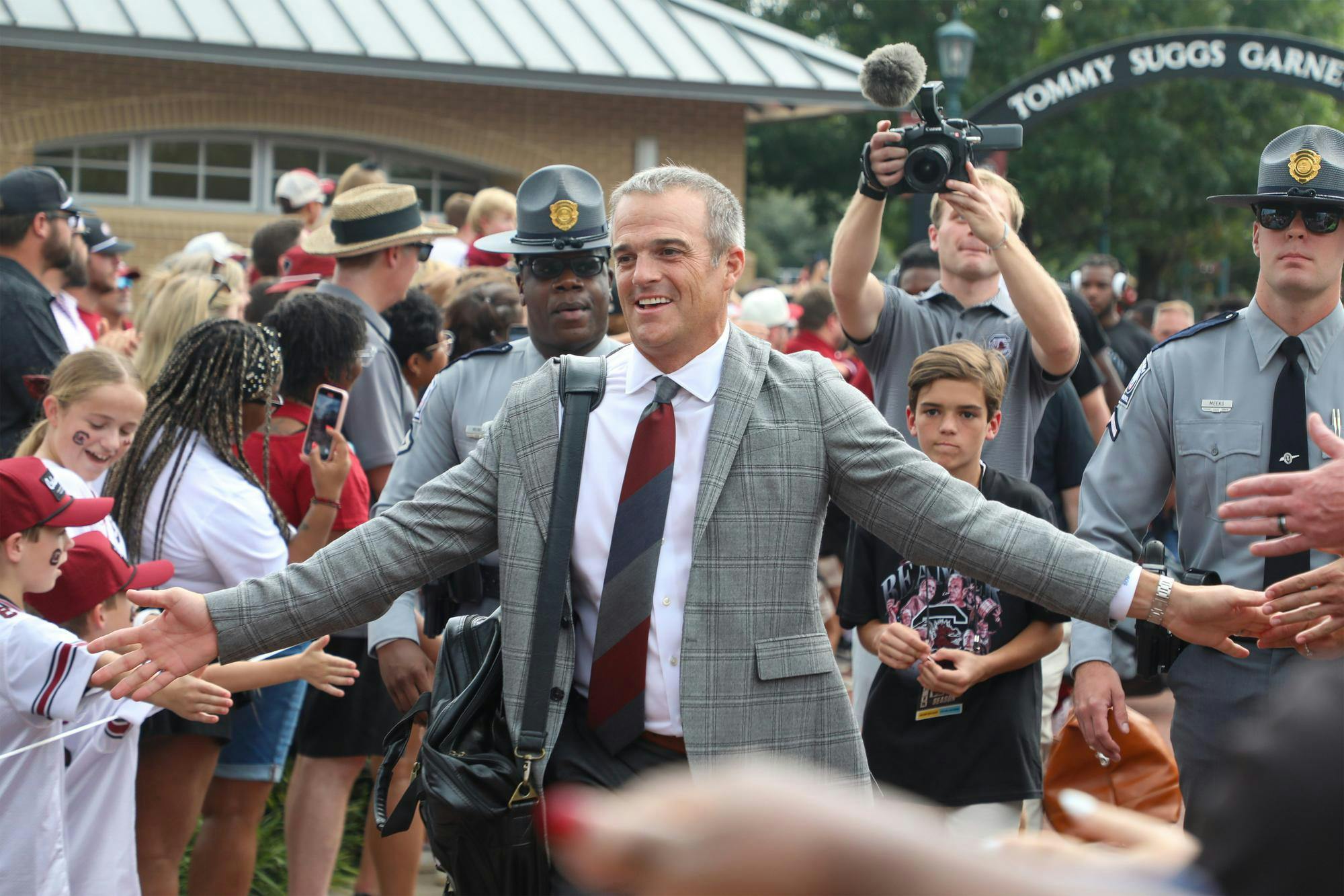FILE — South Carolina football head coach Shane Beamer walks down a pathway surrounded by fans during Gamecock Walk on Sept. 6, 2025. The Gamecocks ended their 2025 season with a 4-8 record.
