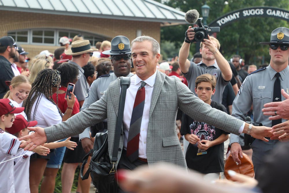 <p>FILE — South Carolina football head coach Shane Beamer walks down a pathway surrounded by fans during Gamecock Walk on Sept. 6, 2025. The Gamecocks ended their 2025 season with a 4-8 record.</p>