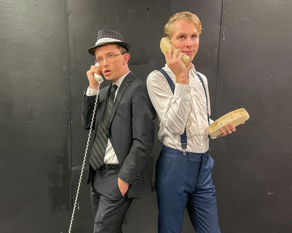 <p>Jack Child (cast as FBI agent Carl Hanratty), on left, and Devyn Porter (cast as Frank Abagnale Jr.), on right, pose for a photograph while holding telephones during the organization’s PR day on Nov. 6, 2022. Off Off Broadway is performing "Catch Me If You Can" at Benson Theatre from Nov. 17-20.&nbsp;</p>