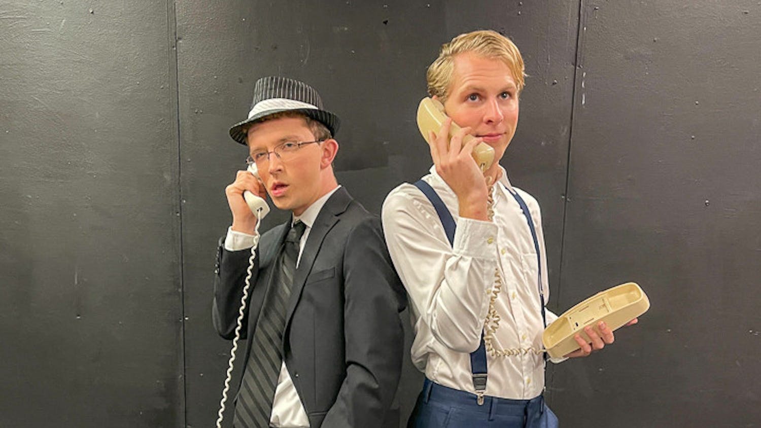 Jack Child (cast as FBI agent Carl Hanratty), on left, and Devyn Porter (cast as Frank Abagnale Jr.), on right, pose for a photograph while holding telephones during the organization’s PR day on Nov. 6, 2022. Off Off Broadway is performing "Catch Me If You Can" at Benson Theatre from Nov. 17-20.&nbsp;