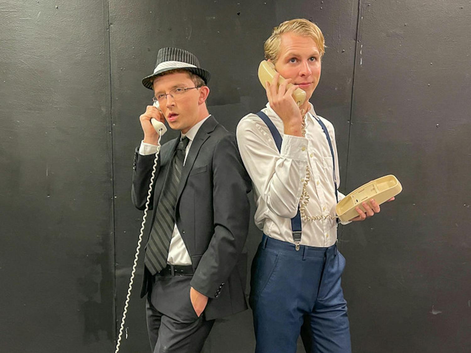 Jack Child (cast as FBI agent Carl Hanratty), on left, and Devyn Porter (cast as Frank Abagnale Jr.), on right, pose for a photograph while holding telephones during the organization’s PR day on Nov. 6, 2022. Off Off Broadway is performing "Catch Me If You Can" at Benson Theatre from Nov. 17-20. 
