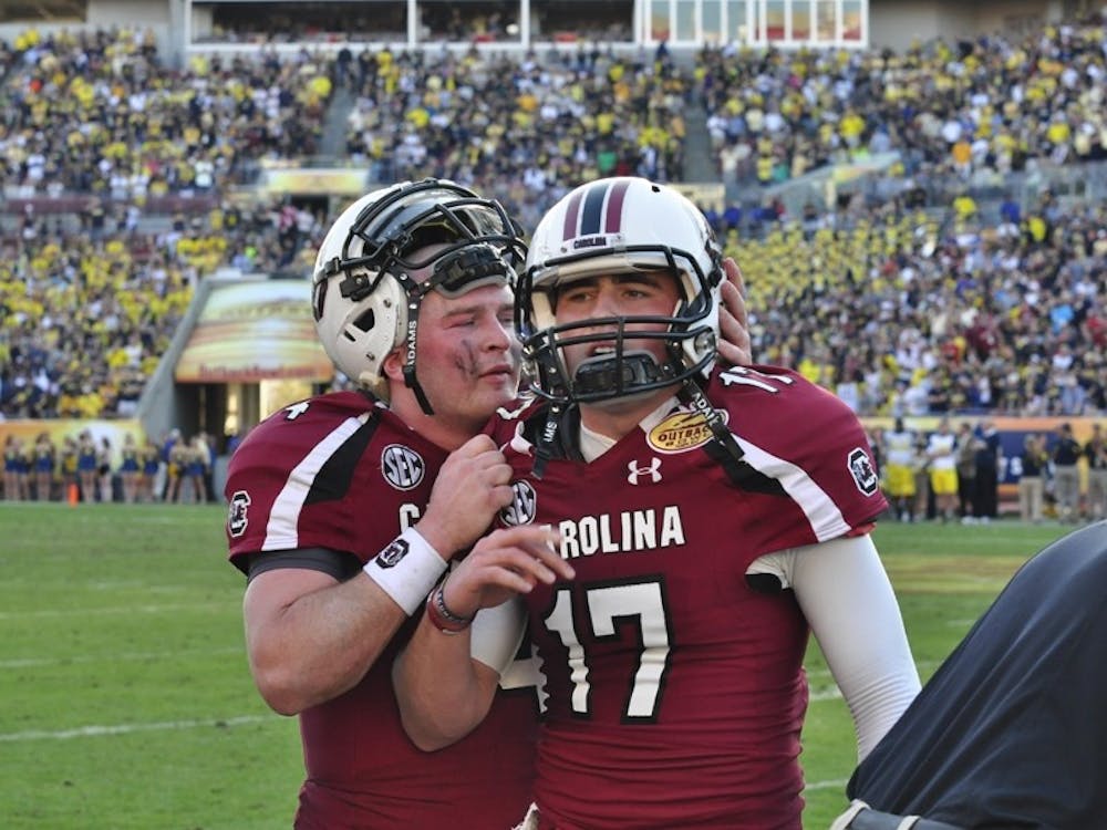 Junior quarterback Connor Shaw (left) was pulled from the game in the middle of USC’s final possession. Sophomore Dylan Thompson (right) threw the game-winning pass.