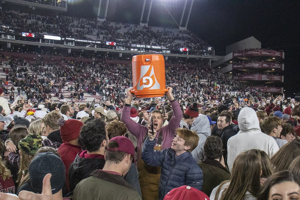 <p>FILE—A South Carolina fan raises the Gatorade jug used to douse Gamecock head football coach Shane Beamer into the air after the 63-38 upset against Tennessee at Williams-Brice Stadium on Nov. 19, 2023. Gamecock students and fans rushed the field en masse after the unanticipated win over the Volunteers.</p>