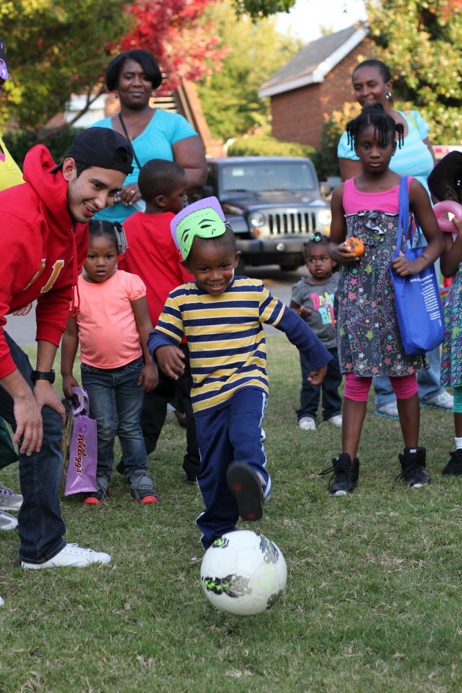 Derrick Ravenell kicks a soccer goal in order to win candy at one of the booths.