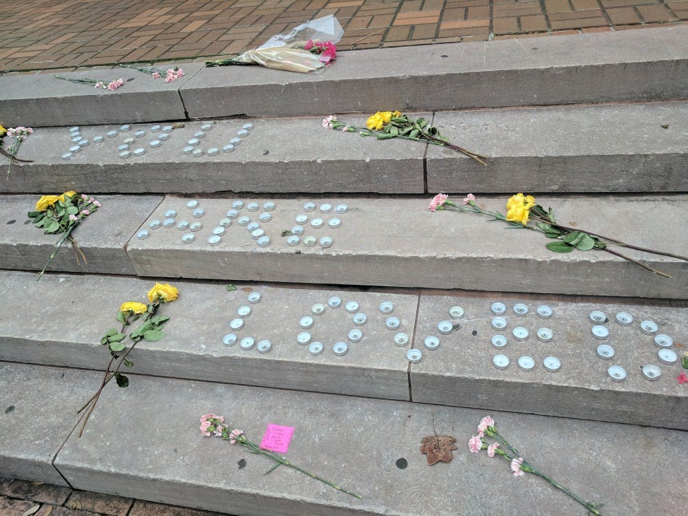 A memorial of tea lights and flowers appeared on the steps in front of Gambrell Hall.