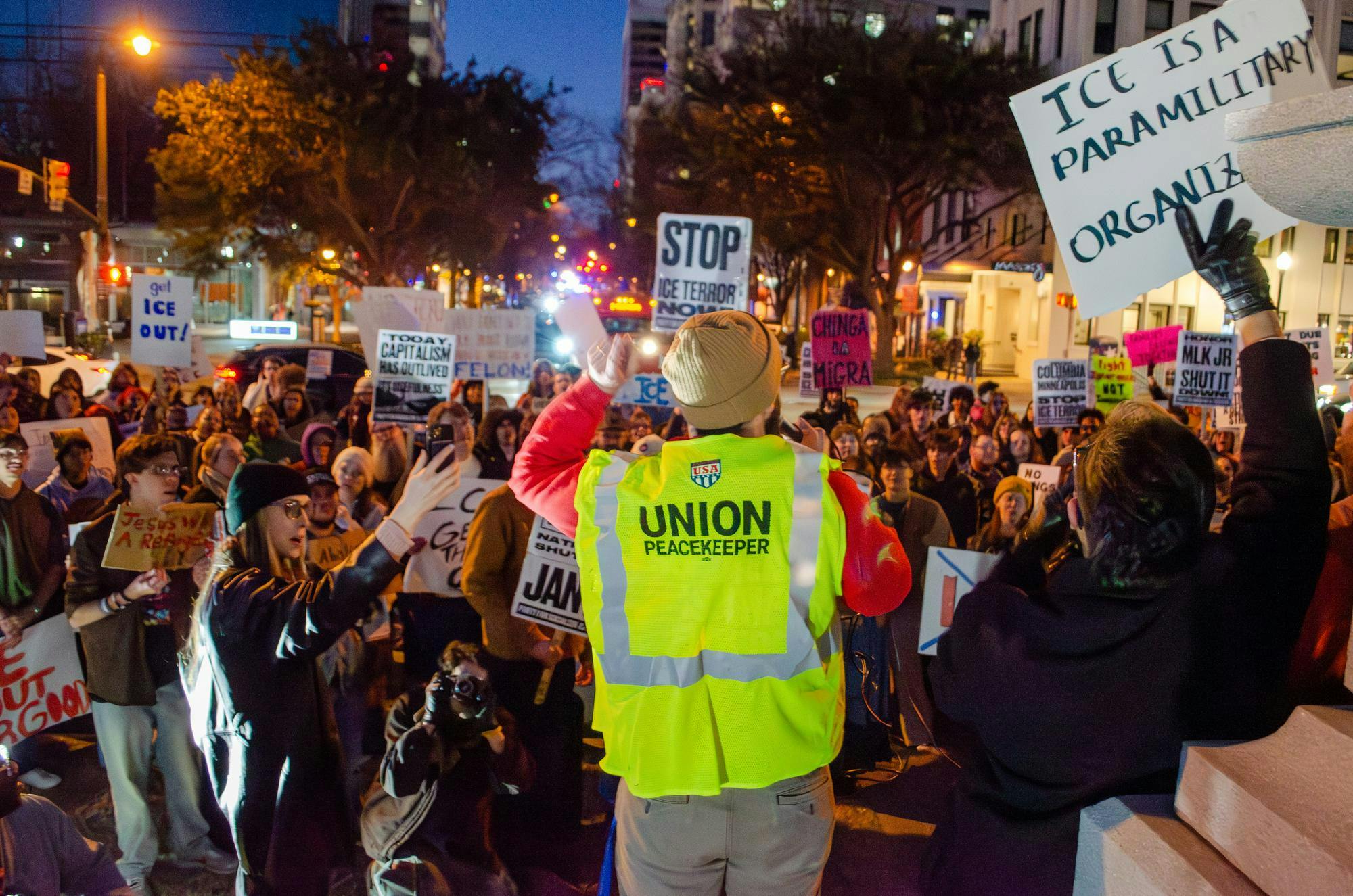 Anson Foster, of the Party for Socialism and Liberation, speaks to the crowd through a megaphone as they prepare to march to Columbia City Hall. The protesters, a large number of whom are students, hold signs opposing the actions of the Trump administration and U.S. Immigration and Customs Enforcement.