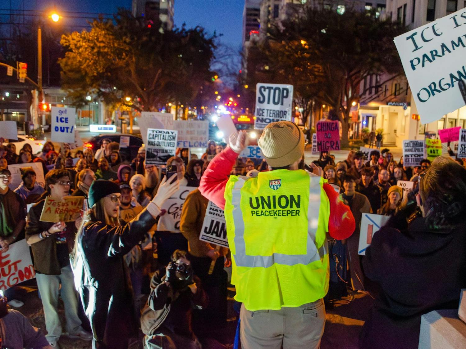 Anson Foster, of the Party for Socialism and Liberation, speaks to the crowd through a megaphone as they prepare to march to Columbia City Hall. The protesters, a large number of whom are students, hold signs opposing the actions of the Trump administration and U.S. Immigration and Customs Enforcement.