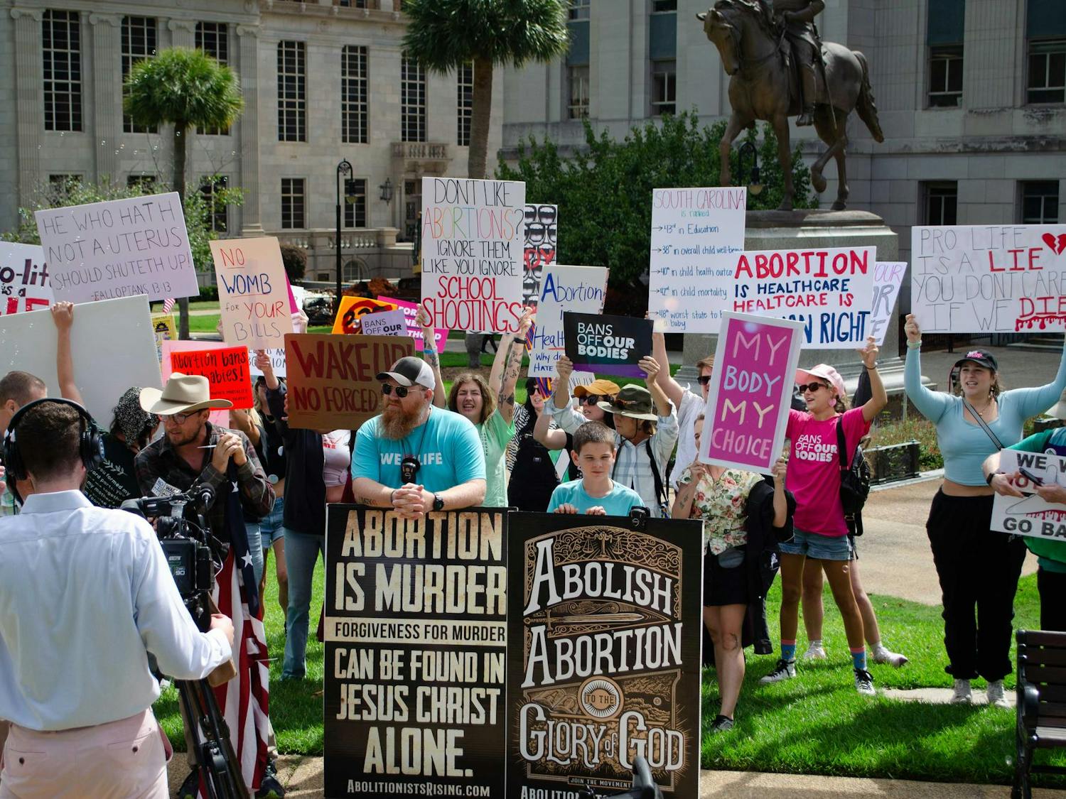 Protestors in support of abortion rights surround a small group of counter-protestors who are for the outlawing of abortion at the South Carolina State Capitol on Oct. 1, 2025.