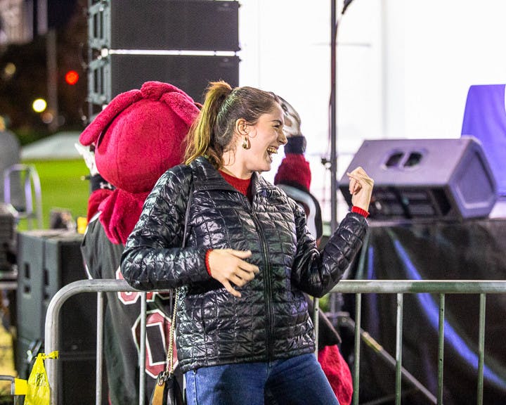 Third-year nursing major Rose Ferguson plays the air-guitar with Cockey during the playing of "Eye of the Tiger" after the USC Tiger Burning on Nov. 21, 2022. USC hosts this event annually during the week leading up to the South Carolina-Clemson football rival match the following Saturday. This year Clemson is hosting the game at their field, "Death Valley."
