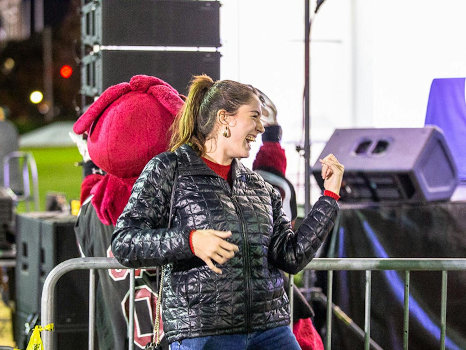 Third-year nursing major Rose Ferguson plays the air-guitar with Cockey during the playing of "Eye of the Tiger" after the USC Tiger Burning on Nov. 21, 2022. USC hosts this event annually during the week leading up to the South Carolina-Clemson football rival match the following Saturday. This year Clemson is hosting the game at their field, "Death Valley."