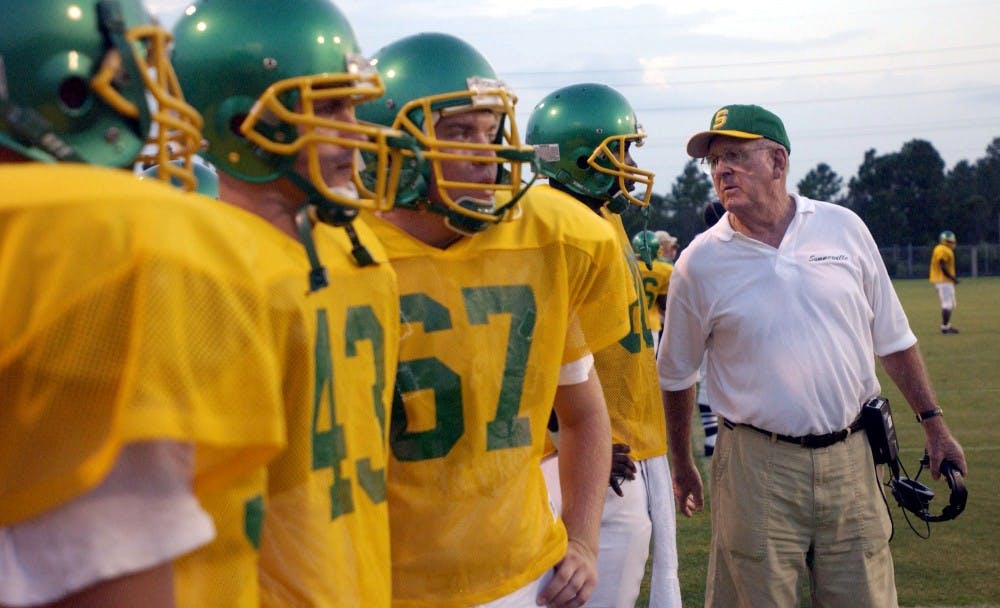 KRT SPORTS STORY SLUGGED: FBH-MCKISSICK KRT PHOTOGRAPH BY TODD BENNETT/THE STATE (September 25) Football coach John McKissick with his players at Summerville, South Carolina. He is the winningest coach in the nation's history. (mvw) 2003