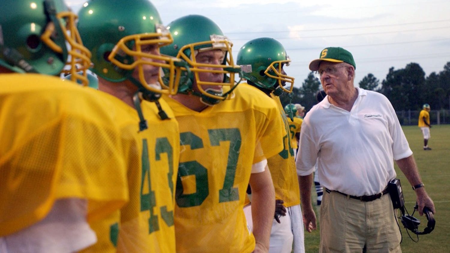 KRT SPORTS STORY SLUGGED: FBH-MCKISSICK KRT PHOTOGRAPH BY TODD BENNETT/THE STATE (September 25) Football coach John McKissick with his players at Summerville, South Carolina. He is the winningest coach in the nation's history. (mvw) 2003