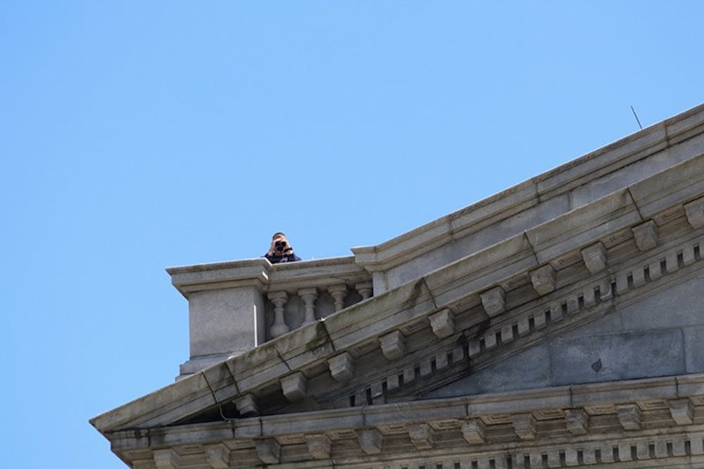 <p>Snipers on the roof of the Statehouse monitor the protest from above.</p>