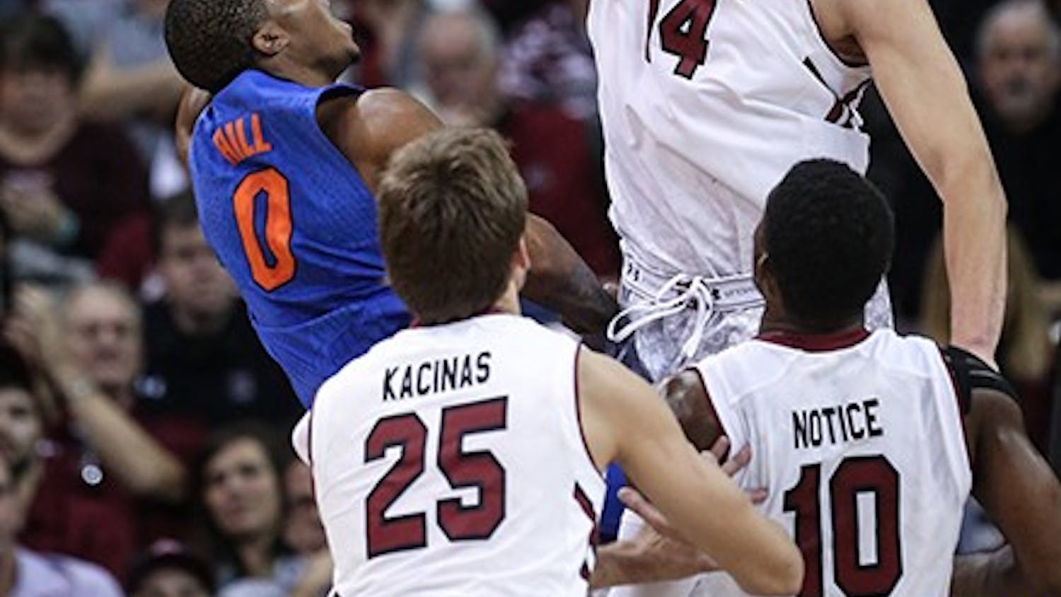 South Carolina forward Laimonas Chatkevicius (14) blocks a shot by Florida guard Kasey Hill (0) during the first half on Wednesday, Jan. 7, 2015, at Colonial Life Arena in Columbia, S.C. (Tracy Glantz/The State/TNS)