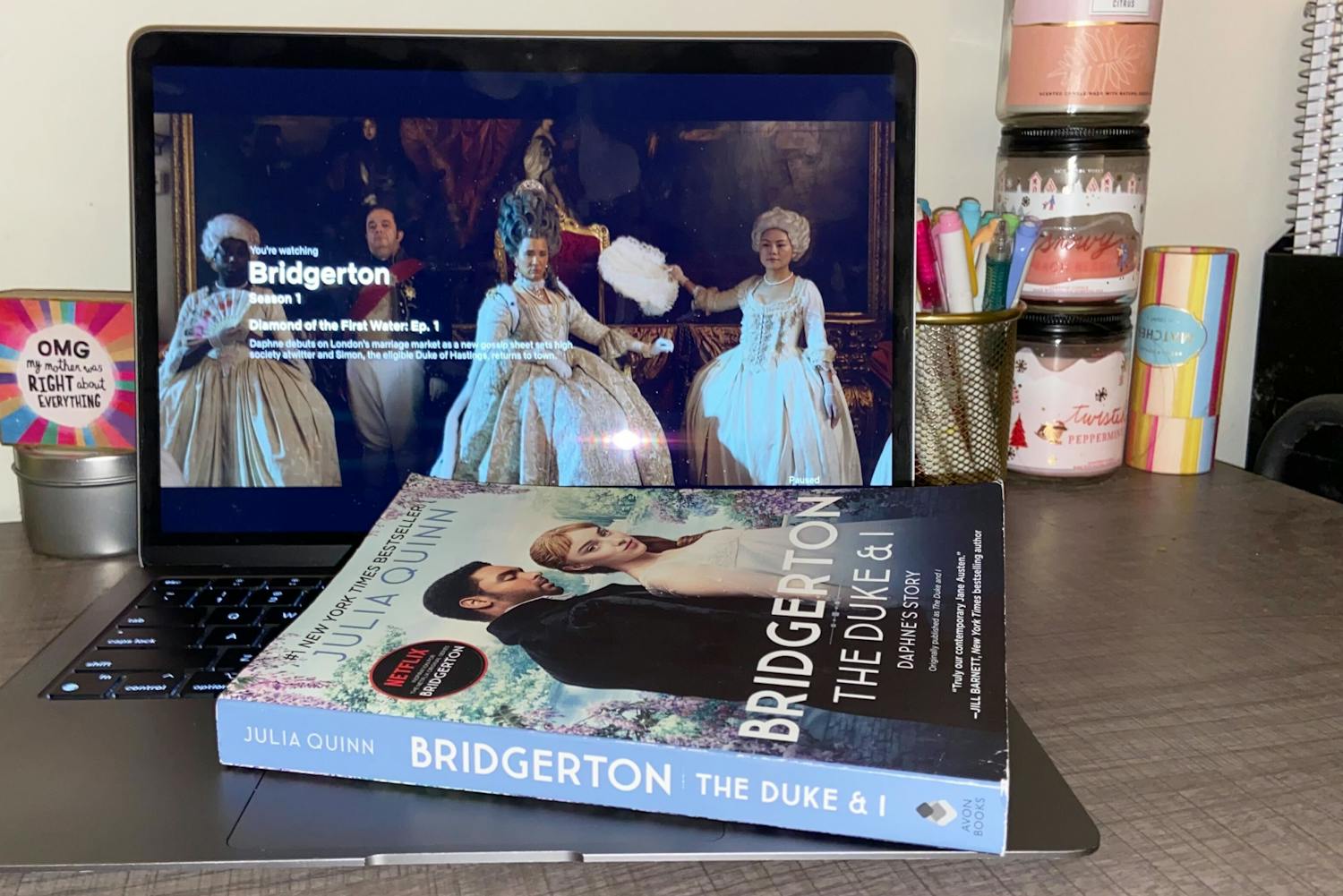 The first Bridgerton book sits on top of a laptop playing the first episode of its TV adaptation. The first 鶹С򽴫ý of Bridgerton was released on Dec. 25, 2020. 