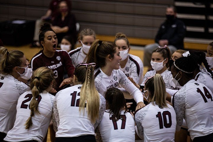 The South Carolina volleyball team huddles around one of its players, who is running and high-fiving her teammates. The Gamecocks played the Tigers on Wednesday, Oct. 28, and Thursday night, Oct. 29, and secured a win on both days.