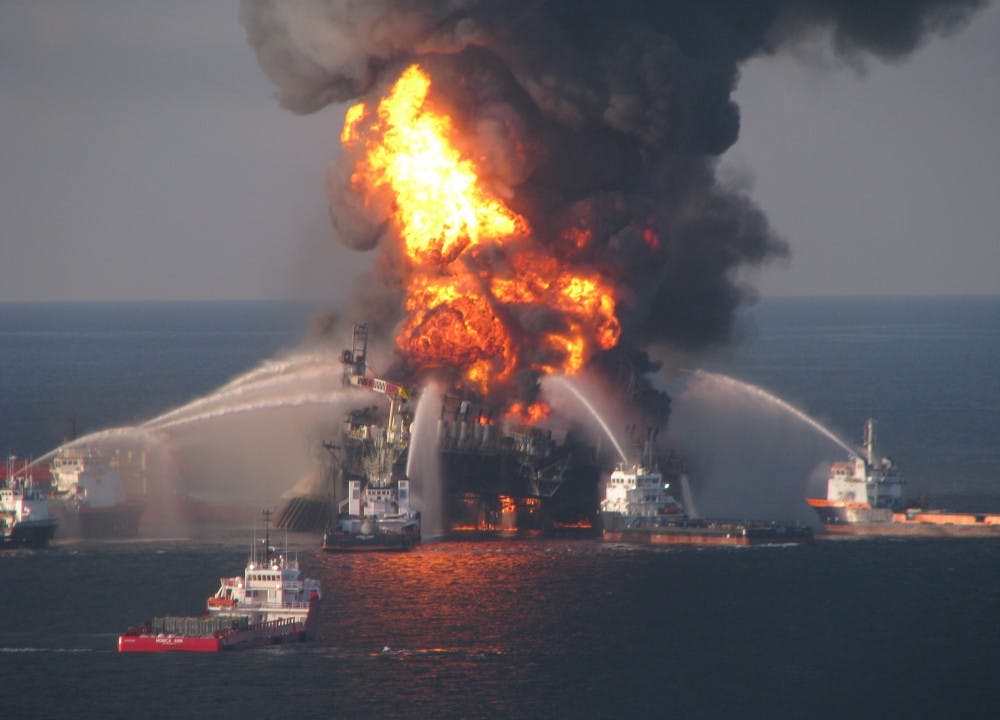 Fire boat response crews battle the blazing remnants of the off shore oil rig Deepwater Horizon April 21, 2010. A Coast Guard MH-65C dolphin rescue helicopter and crew document the fire aboard the mobile offshore drilling unit Deepwater Horizon, while searching for survivors April 21, 2010. Multiple Coast Guard helicopters, planes and cutters responded to rescue the Deepwater Horizon&apos;s 126 person crew. (Petty Officer 3rd Class Tom Atkeson/U.S. Coast Guard/MCT)