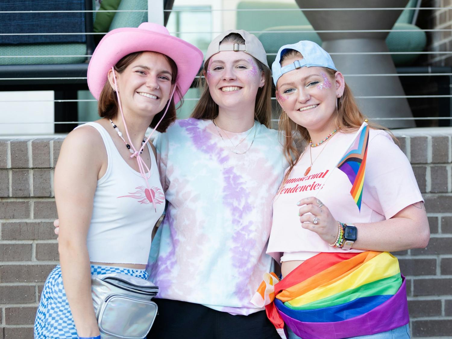 Fourth-year history and philosophy student Kate Kuisel, fourth-year supply chain and HR management student Anne Claire Purcell and Sarah McMurray pose for a picture at Outfest on June 4, 2022. Outfest featured performances, food and vendors in honor of Pride month.&nbsp;