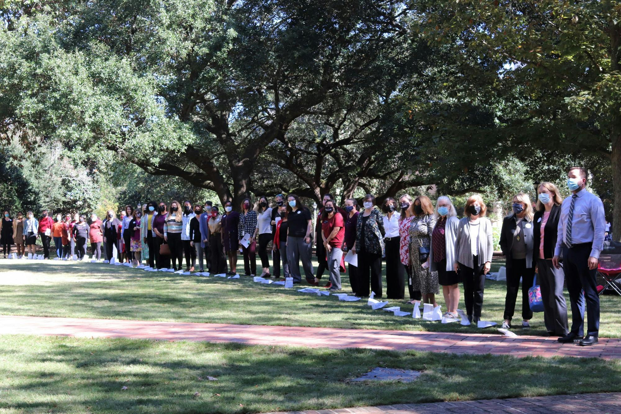 Attendees of the Lighting the Way for Women Leaders event gathers together on the Horseshoe on Oct. 26, 2021.