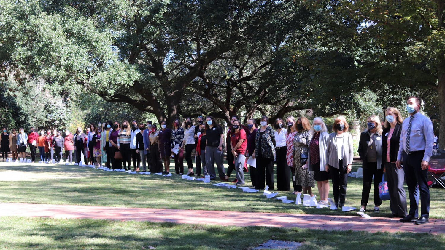 Attendees of the Lighting the Way for Women Leaders event gathers together on the Horseshoe on Oct. 26, 2021.