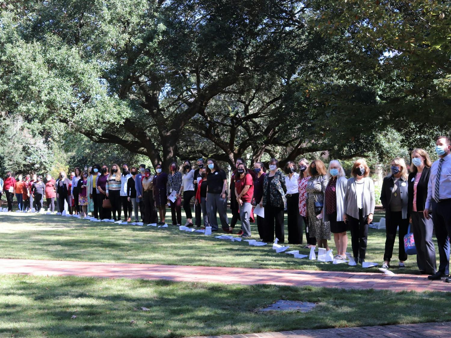 Attendees of the Lighting the Way for Women Leaders event gathers together on the Horseshoe on Oct. 26, 2021.