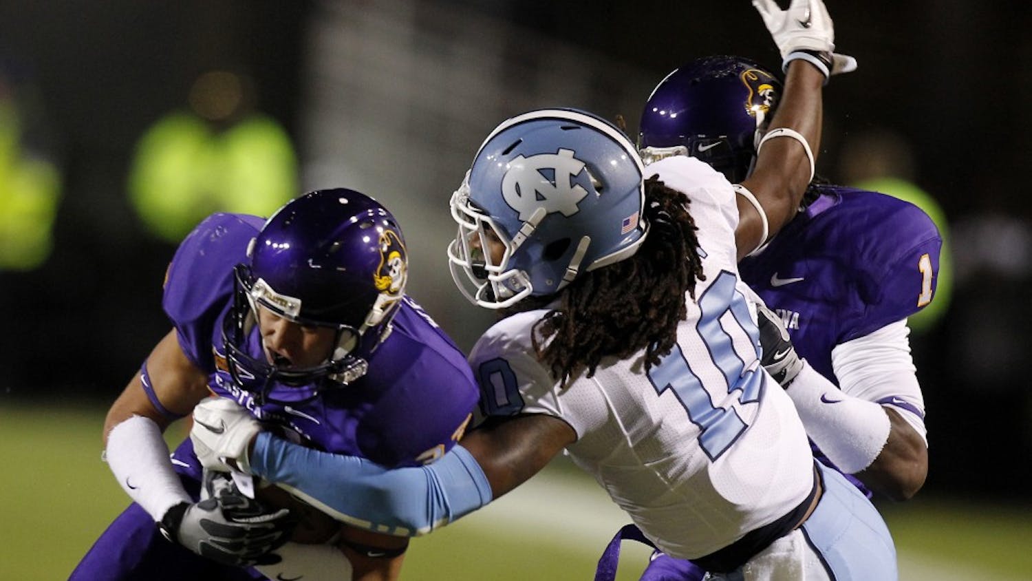 North Carolina safety Tre Boston (10) strips the ball from East Carolina wide receiver Danny Webster (33) in the first quarter on Saturday, October 31, 2011 at Dowdy-Ficklen Stadium in Greenville, North Carolina. (Chuck Liddy/Raleigh News & Observer/MCT)