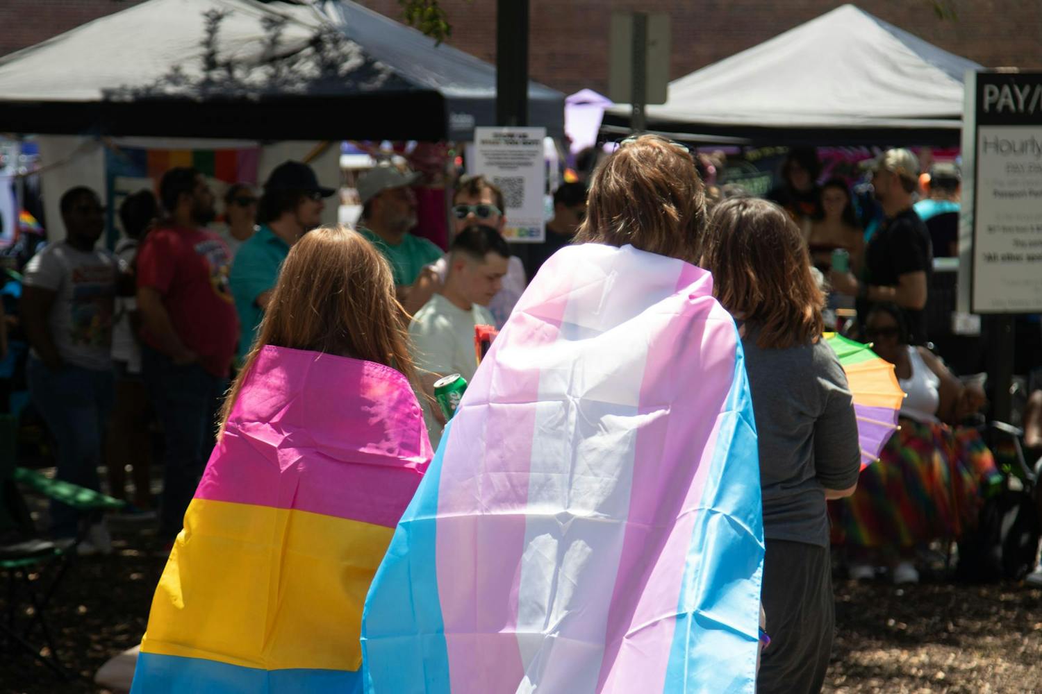Supporters with a pride flags wrapped around their bodies during the drag competition at Outfest on June 1, 2024. Outfest celebrates the LGBTQIA+ community's fortitude and spirit, featuring local talent and businesses during Pride Month.
