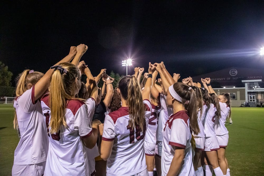 The women's soccer team in a huddle during a time-out during a game against Vanderbilt on September 23, 2021.