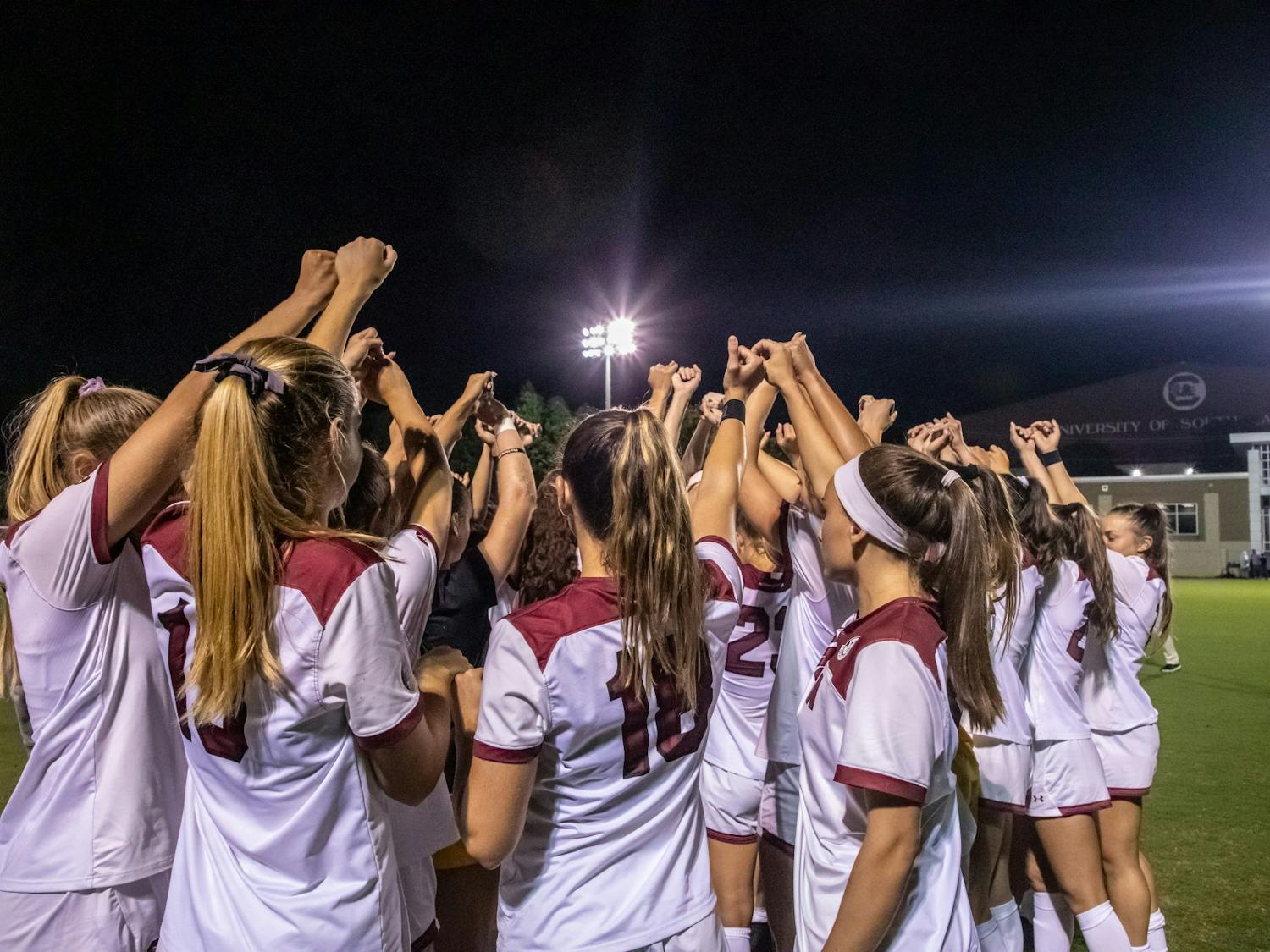 The women's soccer team in a huddle during a time-out during a game against Vanderbilt on September 23, 2021.