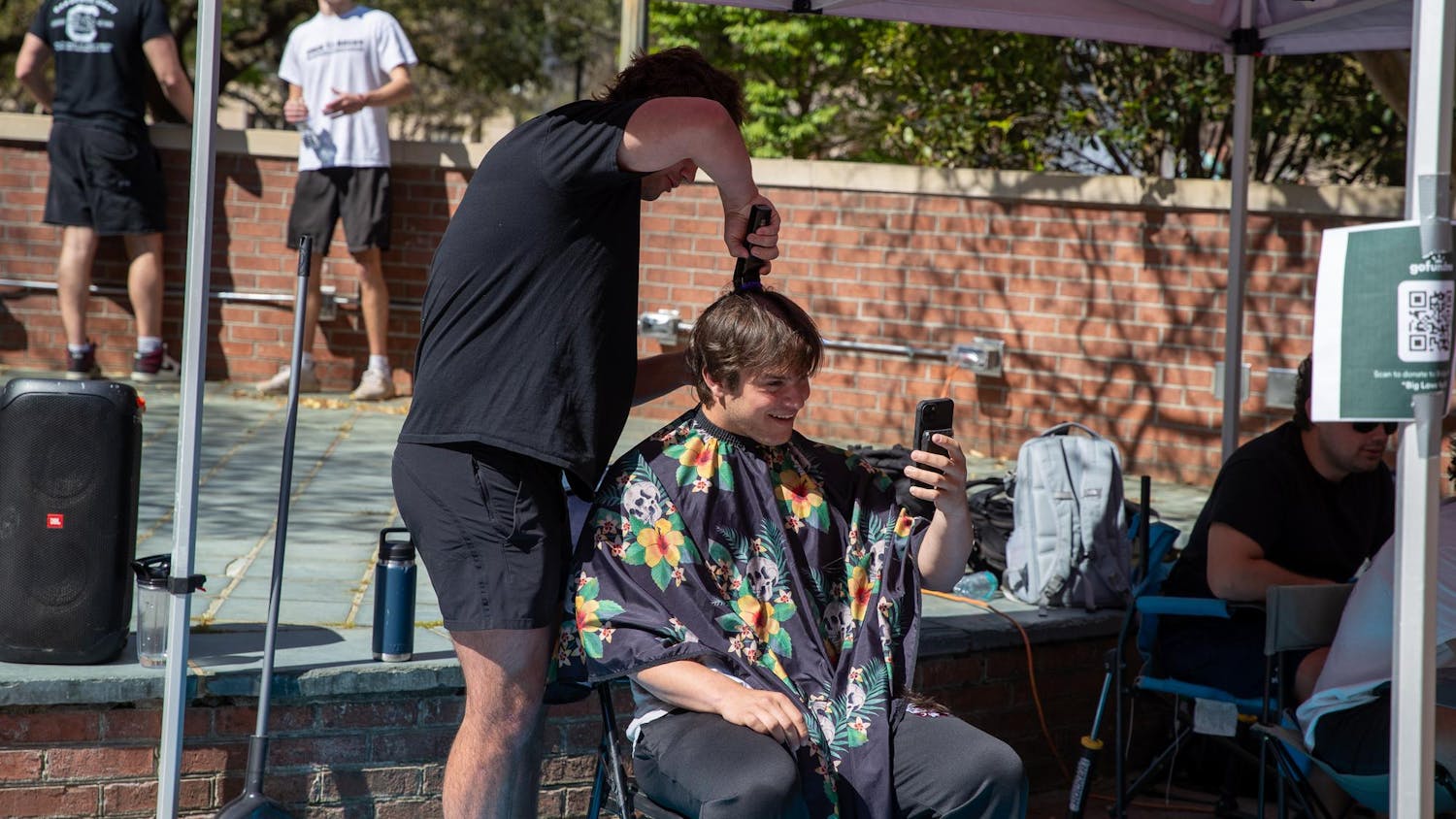 A University of South Carolina club rugby player shaves his head on March 27, 2025 on the Russell House Patio. Players and their friends shaved their heads for their teammate who is currently battling cancer.