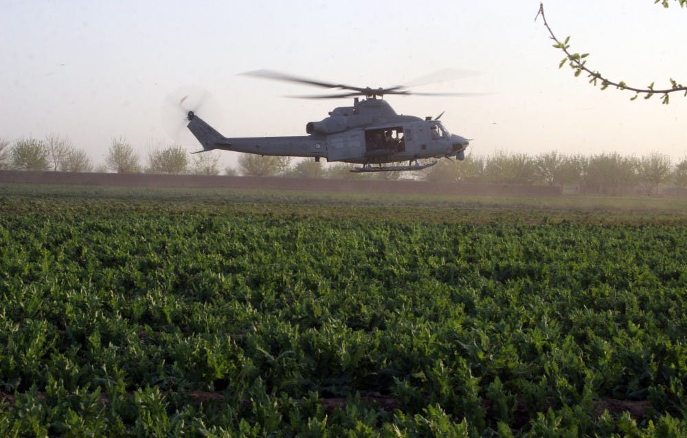 A U.S. Military helicopter lands in a poppy field in Marjah, Afghanistan on Saturday, March 13, 2010. American and Afghan government officials who have taken control of the longtime Taliban stronghold are wrestling with how to deal with the region's vast poppy fields that will be ready to harvest in the next few weeks. (Dion Nissenbaum/MCT)