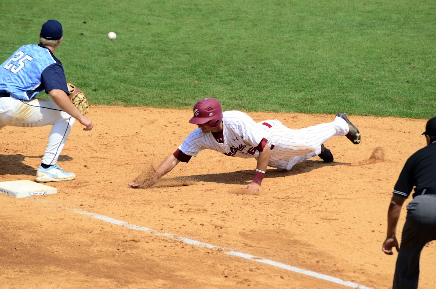 Gamecocks outfielder Graham Saiko dives to first base to avoid an being tagged out.