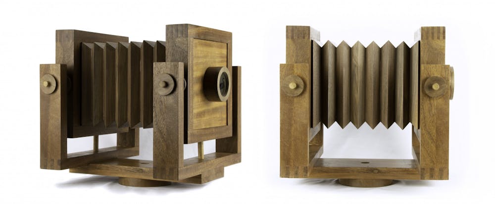 Replica nineteenth-century cameras showcasing ambrotype images of the stuffed birds.