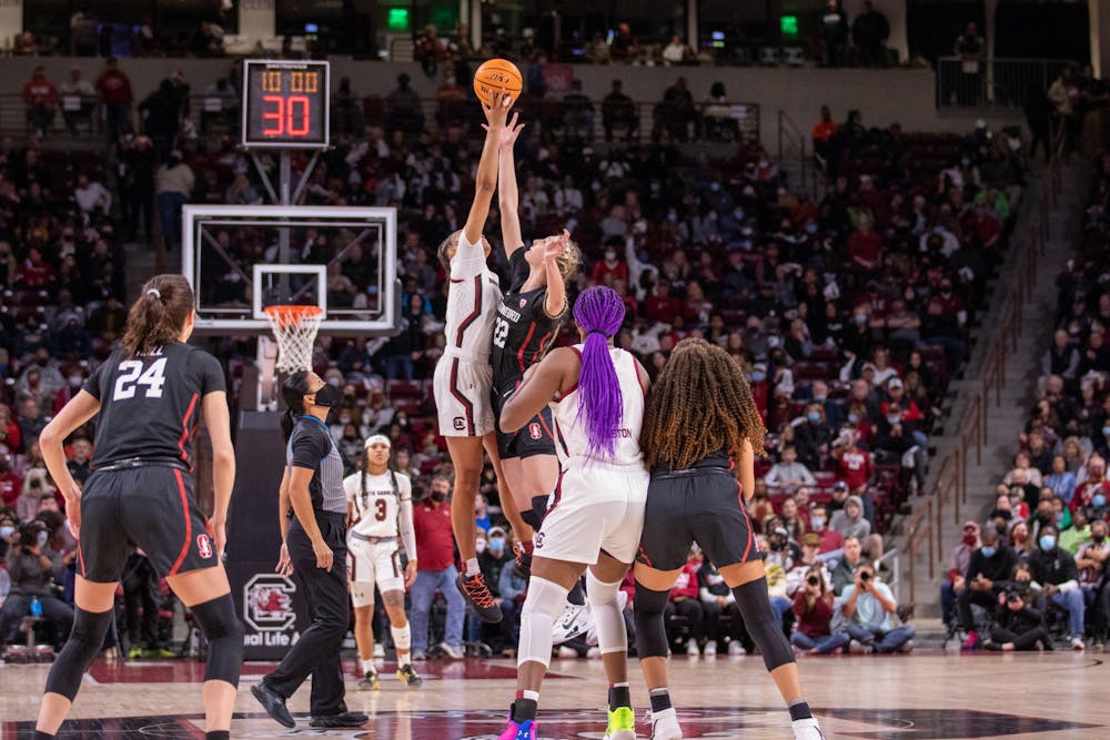 <p>Senior forward Victaria Saxton works to gain possession of the ball during the tip-off on Dec. 22, 2021. The Gamecocks head to Mississippi to battle the Rebels on Jan. 27, 2022</p>